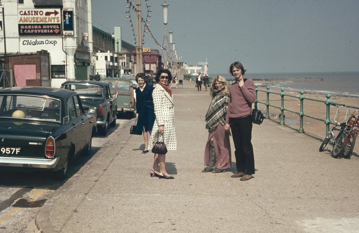 A faded photograph of a family on a seaside promenade